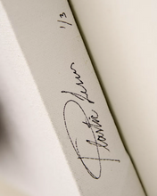 Artist signature on the side of canvas
